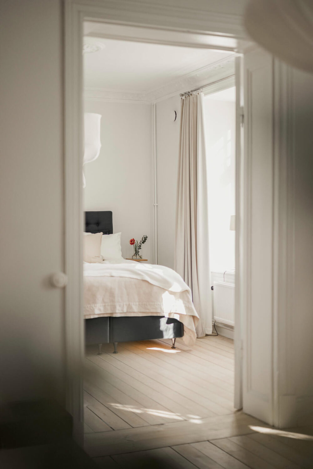 A Bright Swedish Apartment with Period Features and a Green Kitchen 16 peek into bedroom