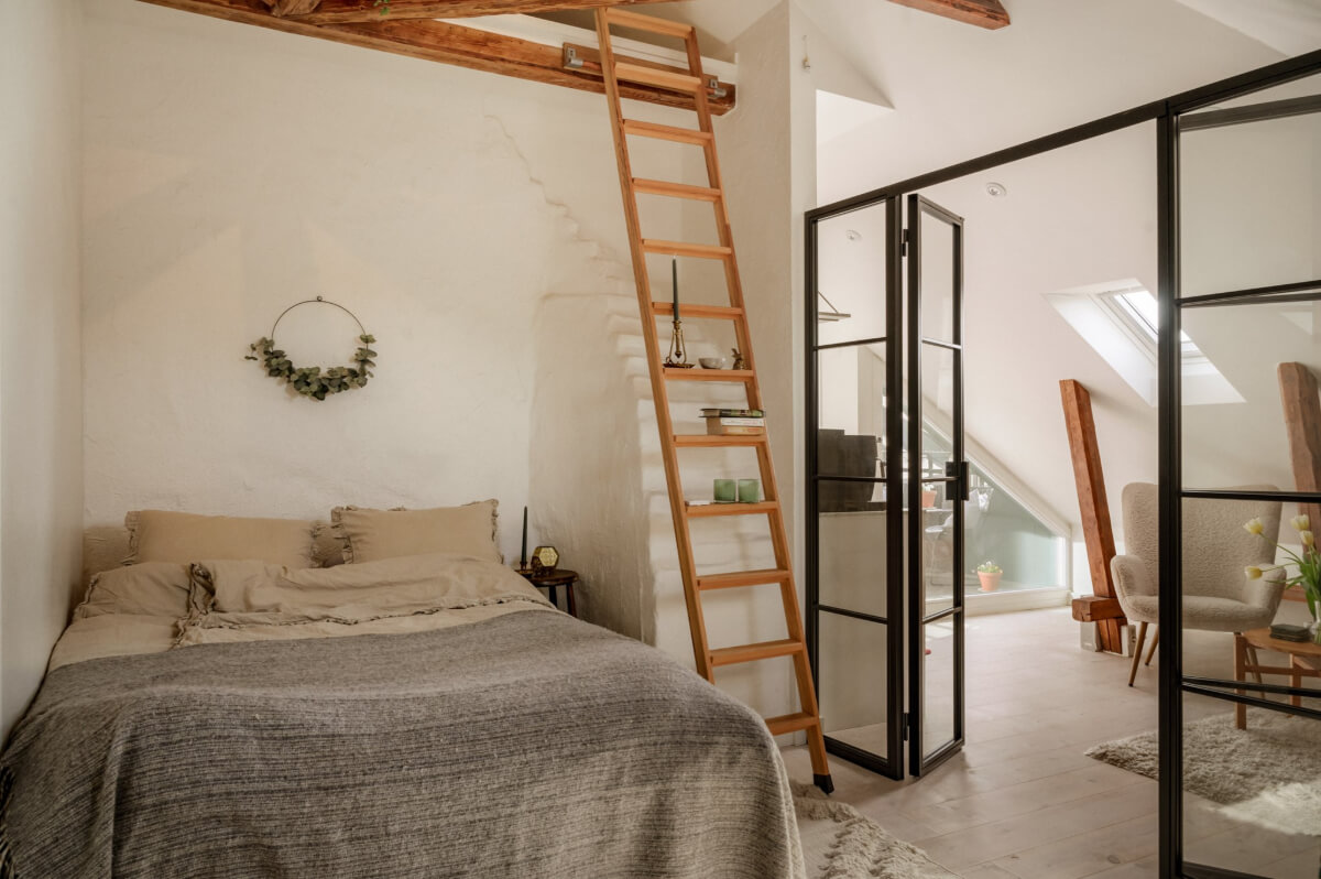 small bedroom white painted brick wall loft area