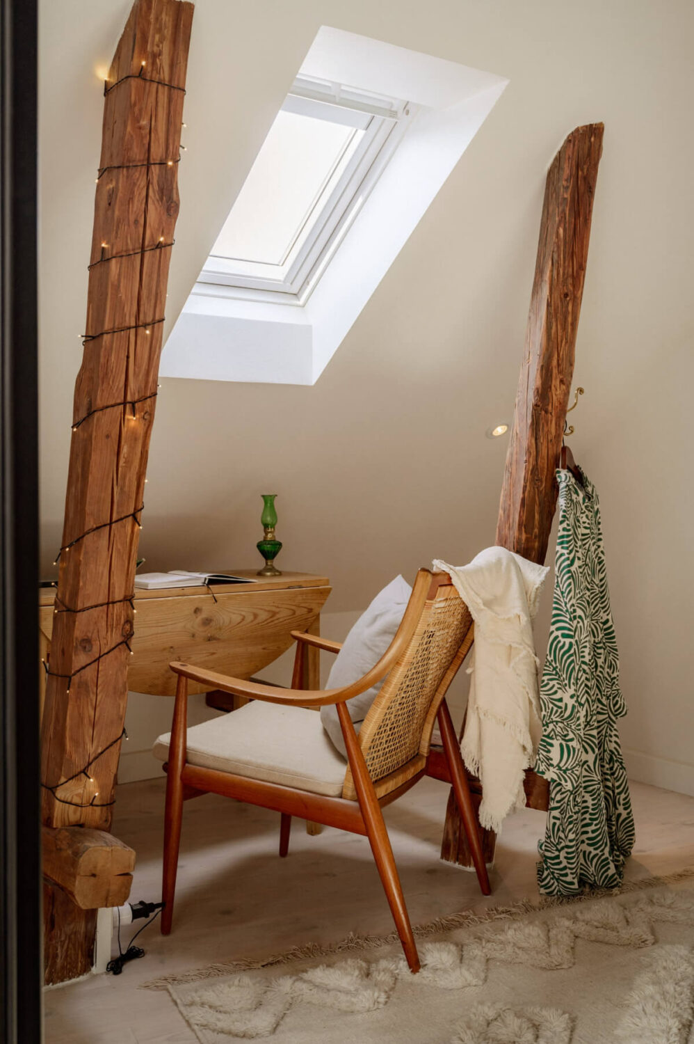 small desk under slanted ceiling exposed beams
