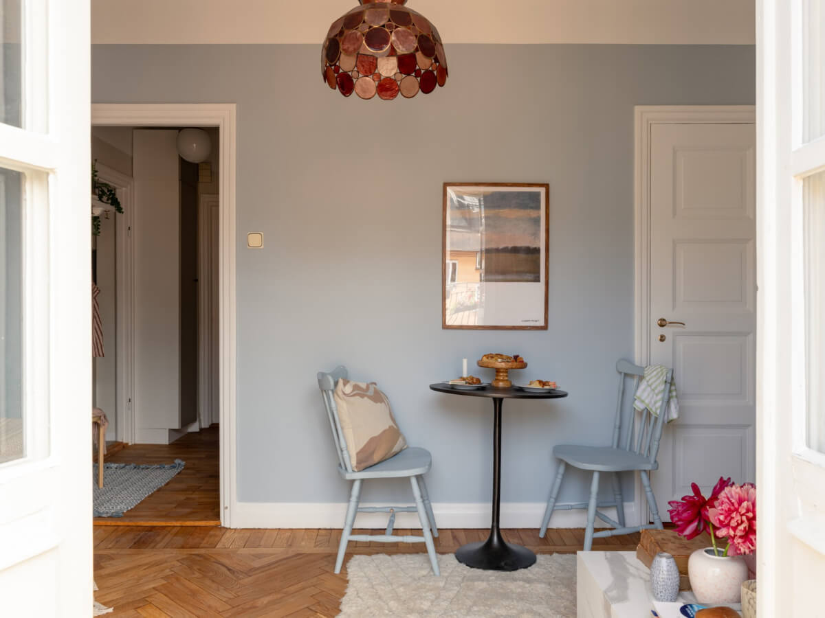 A Blue and Pink Studio Apartment with a Large Balcony 11 small round table