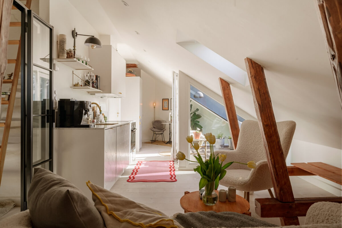 small white attic apartment exposed beams