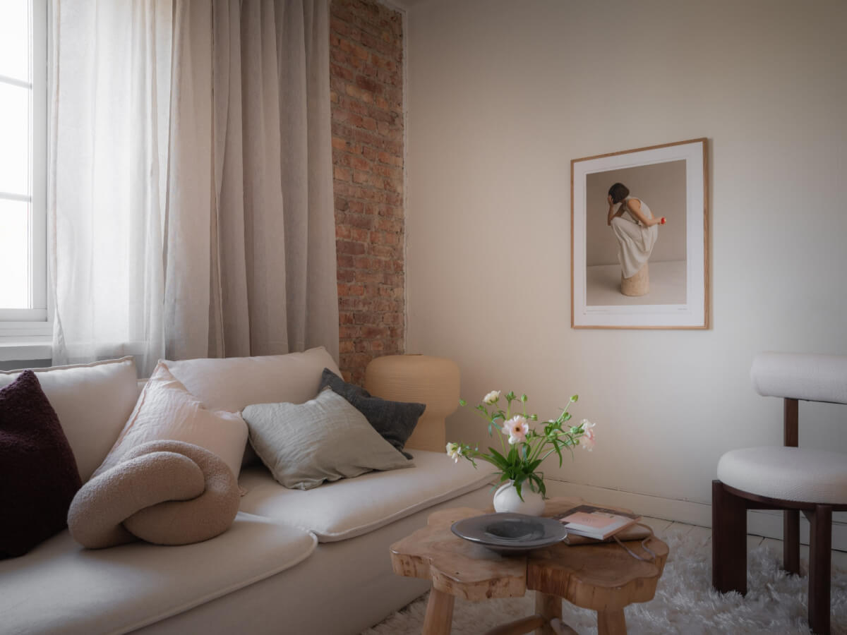 A Light-Colored Studio Apartment with a Cozy Kitchen 4 studio apartment detail brick wall