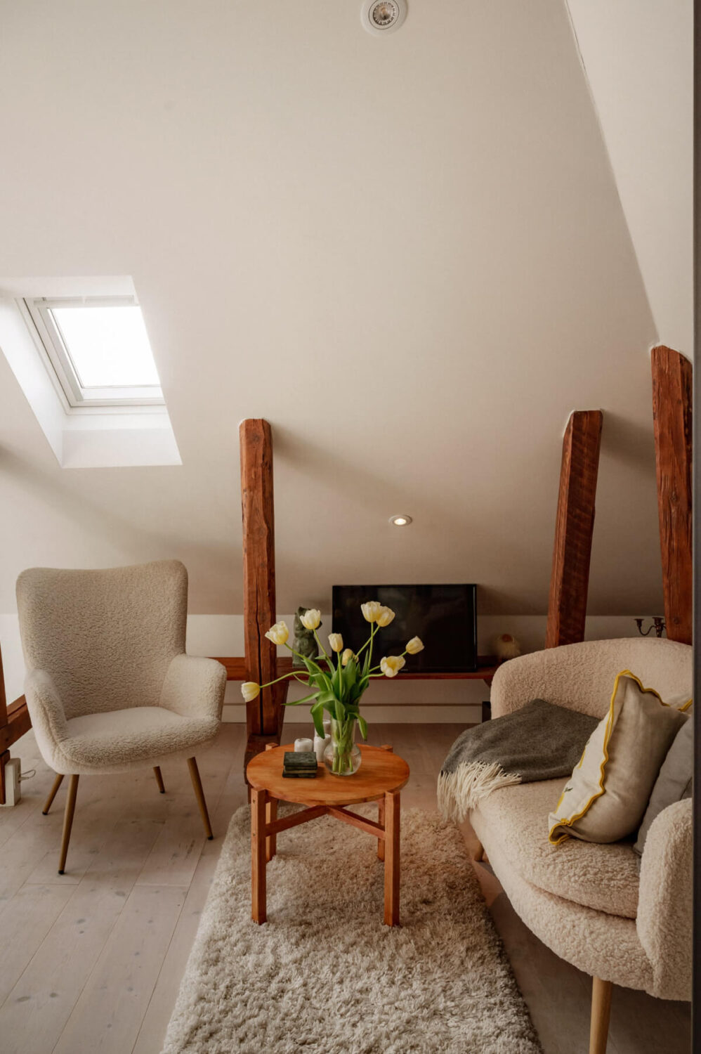 tiny living room slanted ceilings exposed beams