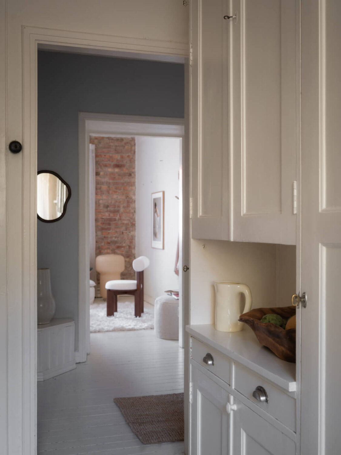 A Light-Colored Studio Apartment with a Cozy Kitchen 15 view into hall