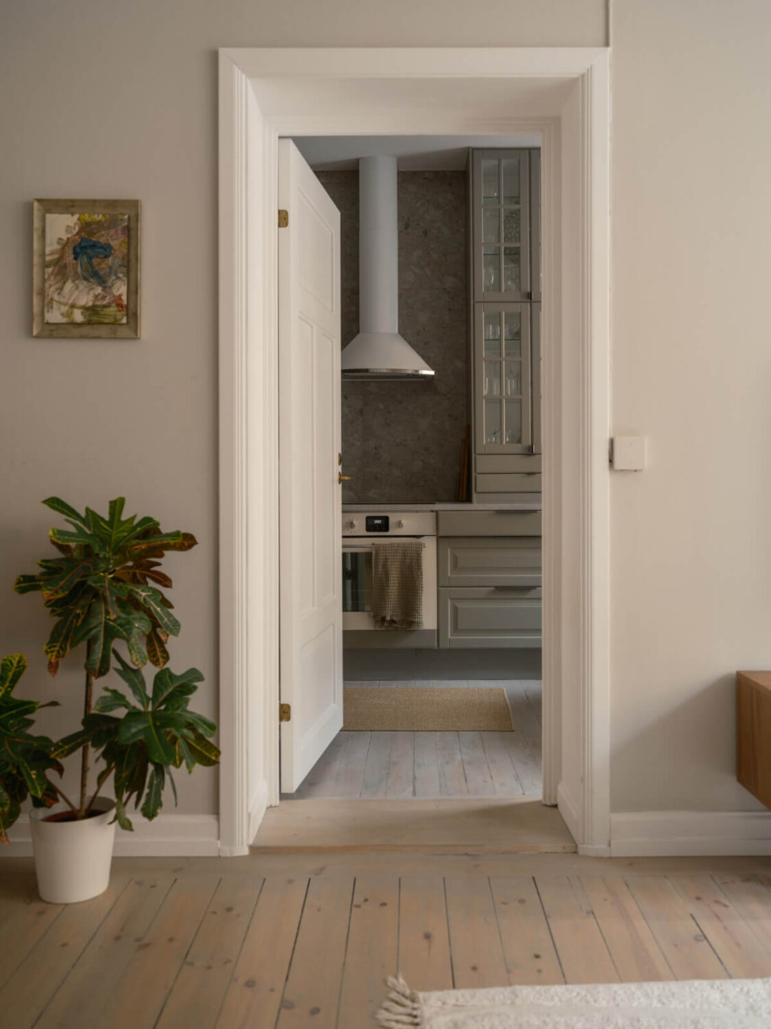 A Muted Palette and a Cozy Kitchen Breakfast Nook in a Swedish Apartment 8 view into kitchen