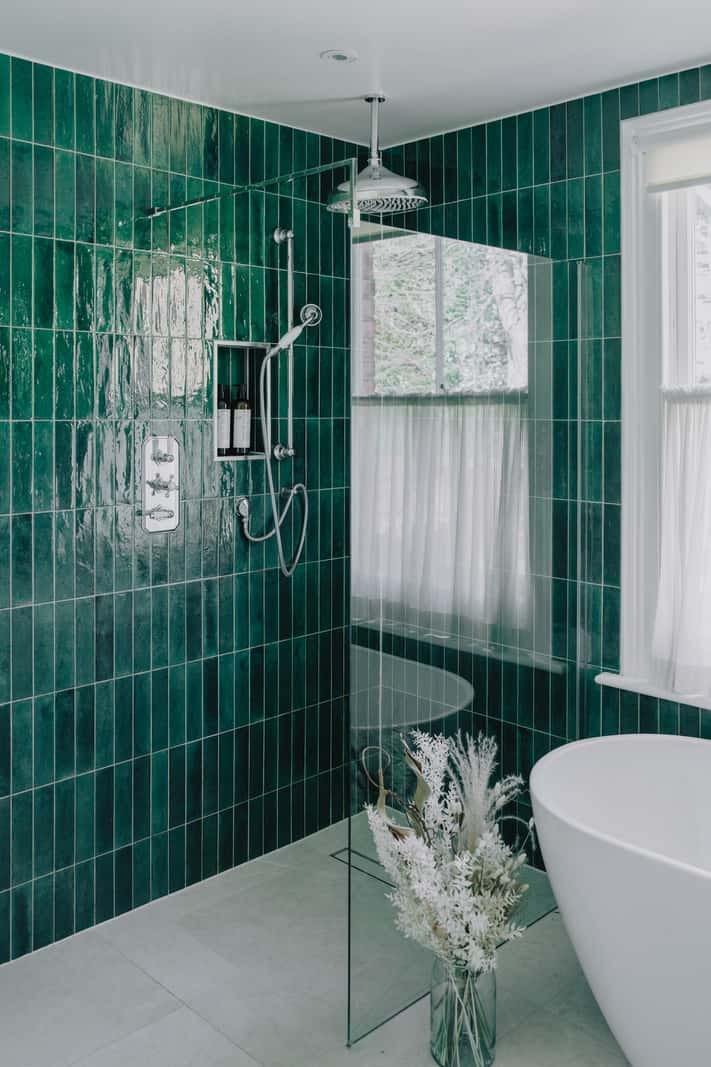 A Serene Color Palette and Built-In Shelves in a London Duplex 21 walk-in shower green tiles