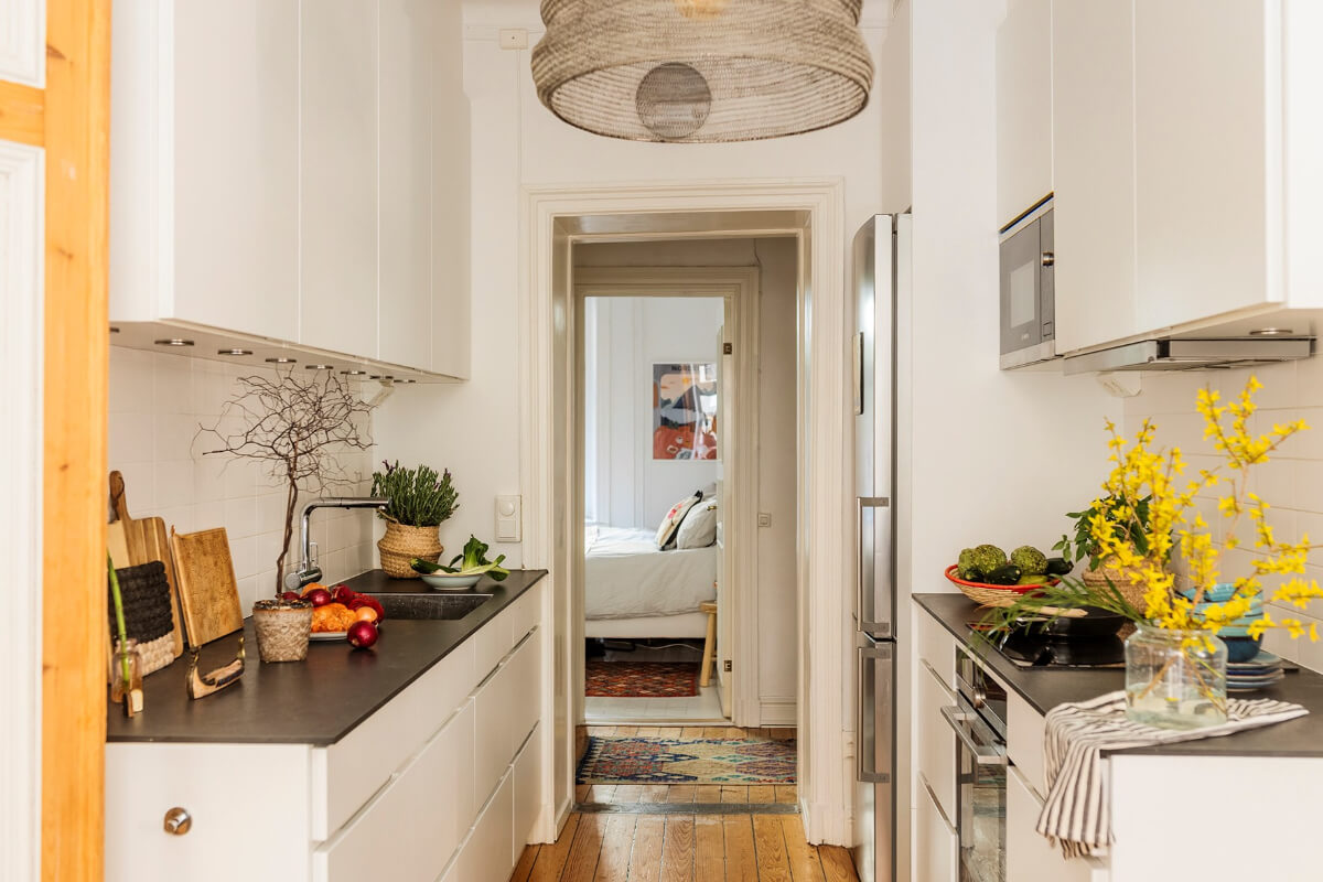 A Bright Family Apartment in Södermalm 10 white kitchen open doorway