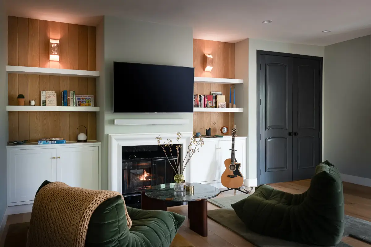 A Creative Sanctuary in Sherman Oaks Designed by Mendy Cheng 18 bedroom sitting area fireplace bookshelves