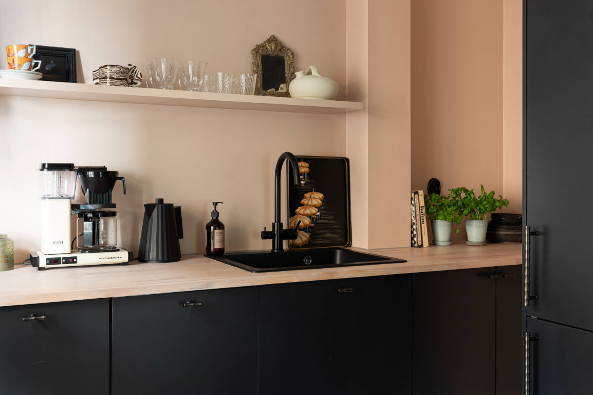 A Pink Studio Apartment with a Modern Black Kitchen 14 black sink modern kitchen