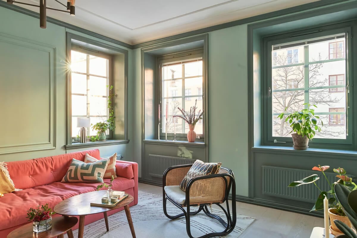 A Green Swedish Corner Apartment with an Open Floor Plan 3 corner apartment large windows green living room