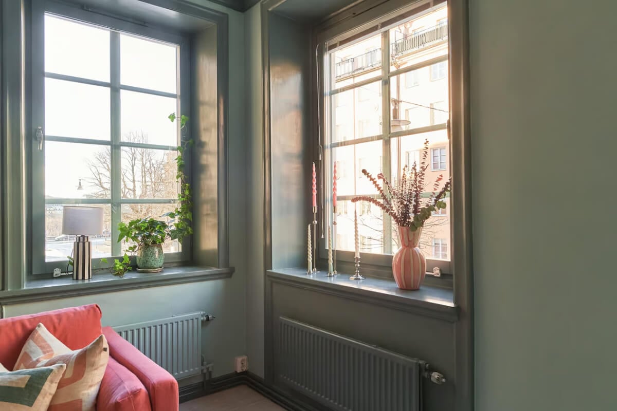A Green Swedish Corner Apartment with an Open Floor Plan 9 corner apartment windows