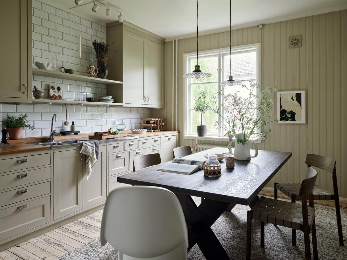 cozy kitchen large wooden table paneled walls