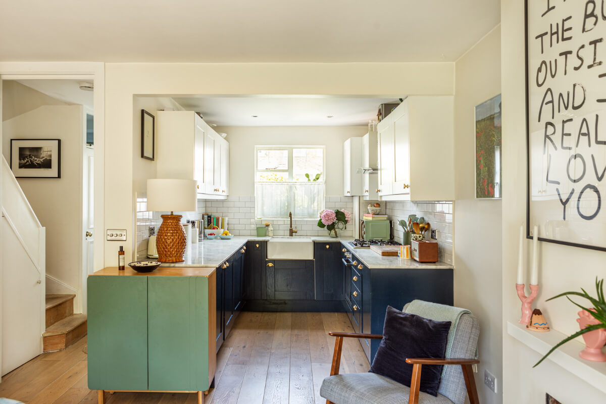 An Open-Plan Living Space and Colorful Bedrooms in a London Duplex 8 dark blue and white kitchen brass fittings