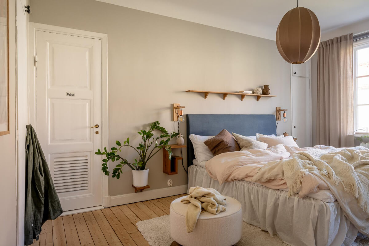 A Cozy Swedish Apartment with a Walk-In Pantry in the Sage Green Kitchen 19 gray bedroom wooden floorboards