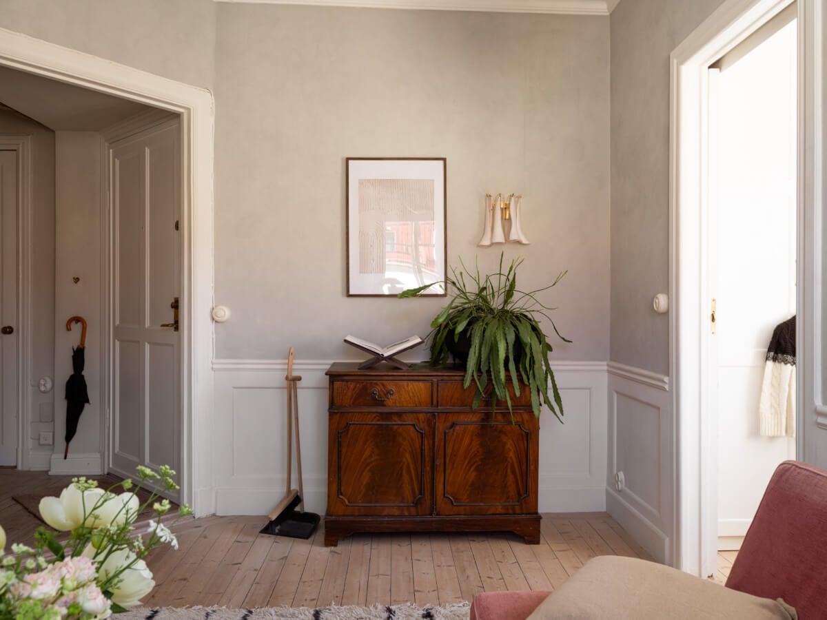 A Small Light-Filled Corner Apartment with Original Details 5 gray walls white wood paneling living room