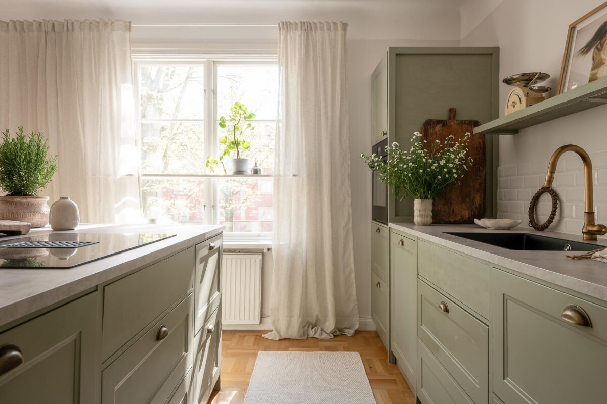 A Cozy Swedish Apartment with a Walk-In Pantry in the Sage Green Kitchen 14 green kitchen large window