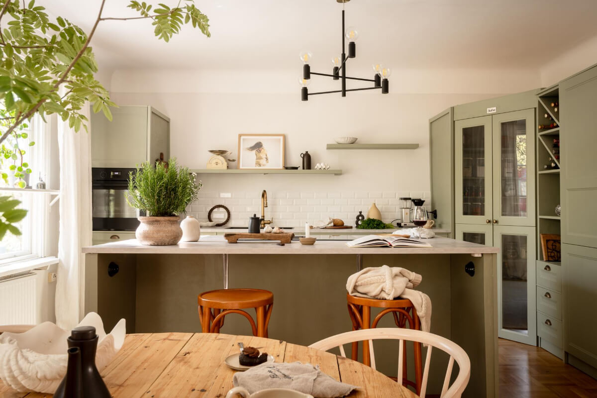 A Cozy Swedish Apartment with a Walk-In Pantry in the Sage Green Kitchen 9 green kitchen with island