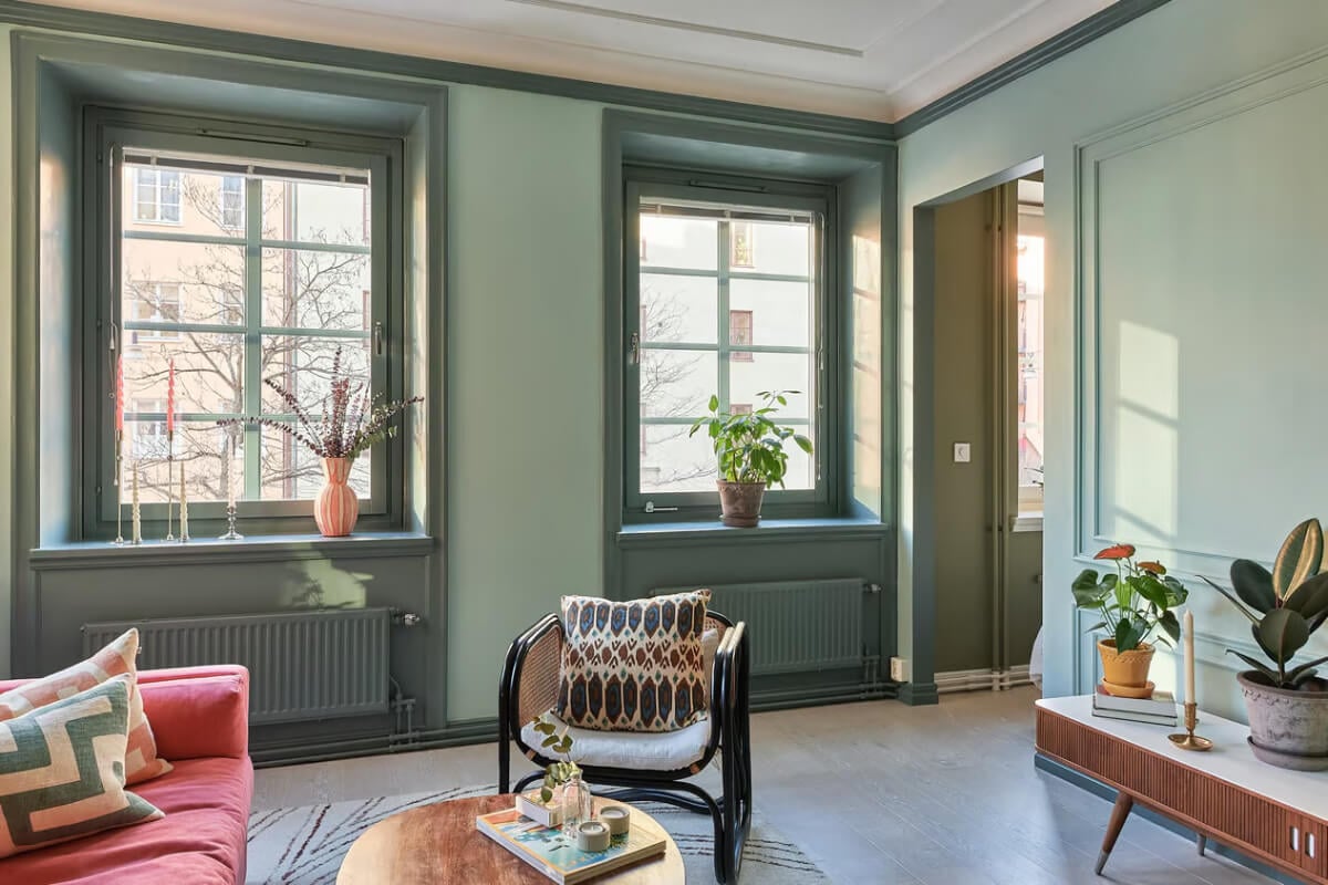 A Green Swedish Corner Apartment with an Open Floor Plan 11 green sitting room large original windows