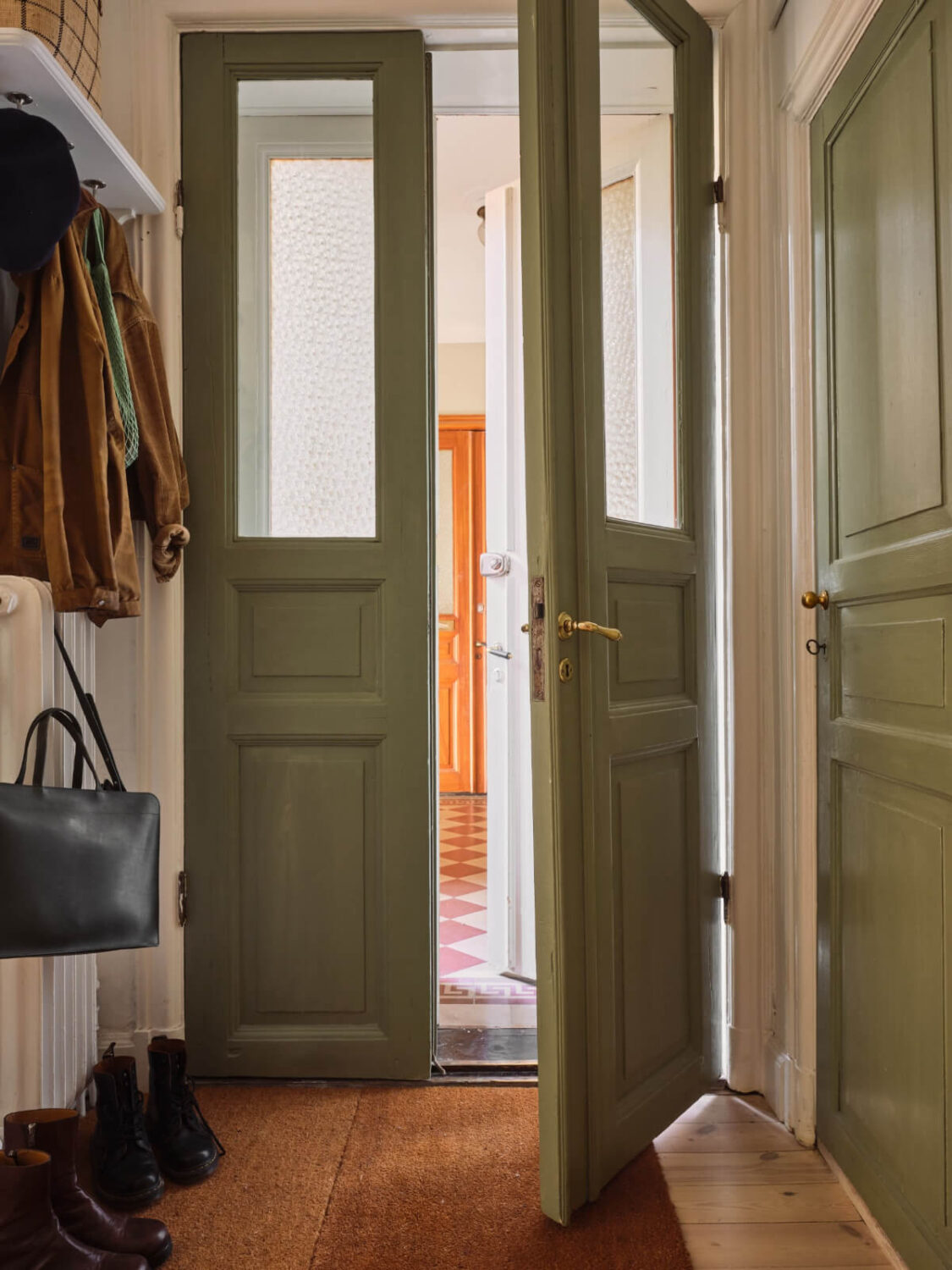 green wooden double front door A Cozy, Tiny Apartment with a Golden Yellow Bedroom
