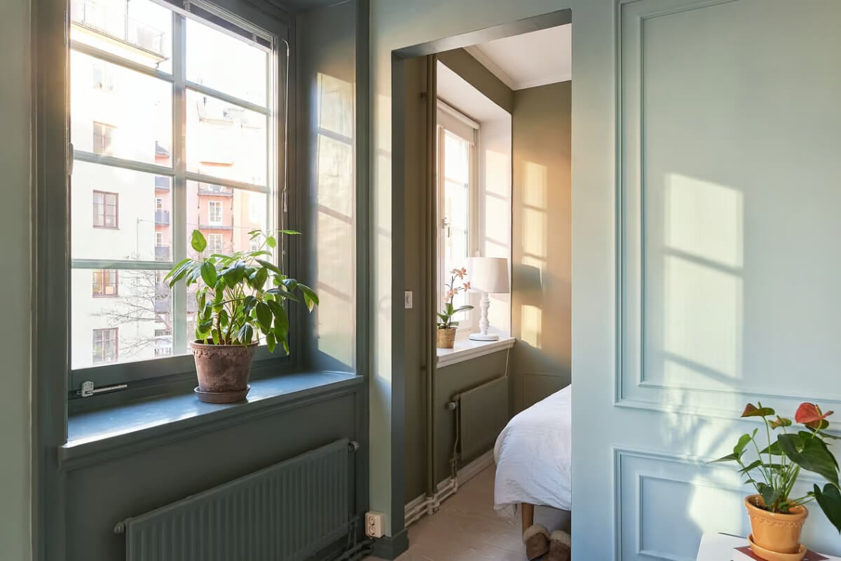 A Green Swedish Corner Apartment with an Open Floor Plan 12 large windows deep niches