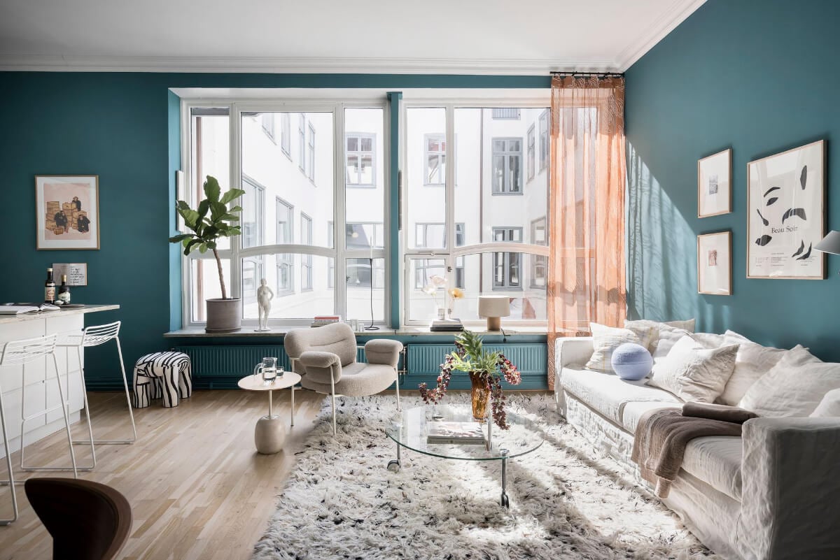 large windows teal green walls living roo