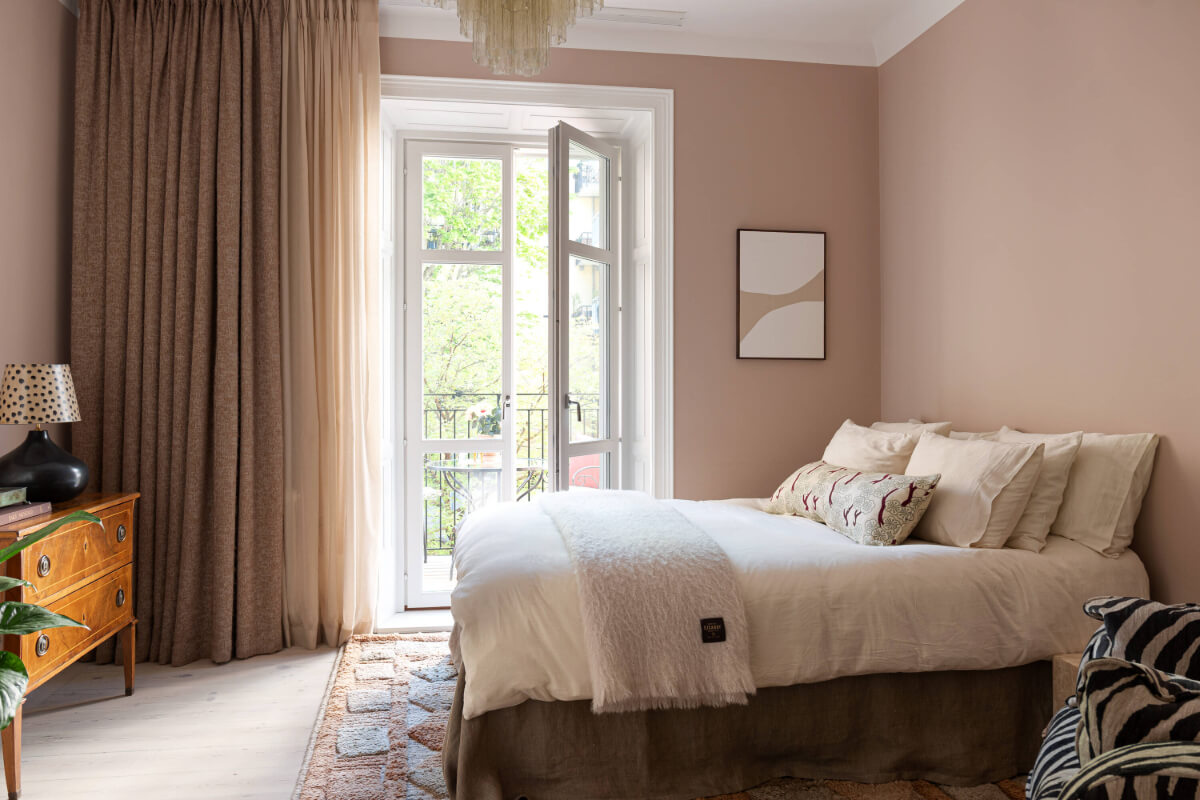 A Pink Studio Apartment with a Modern Black Kitchen 2 pink studio apartment with balcony