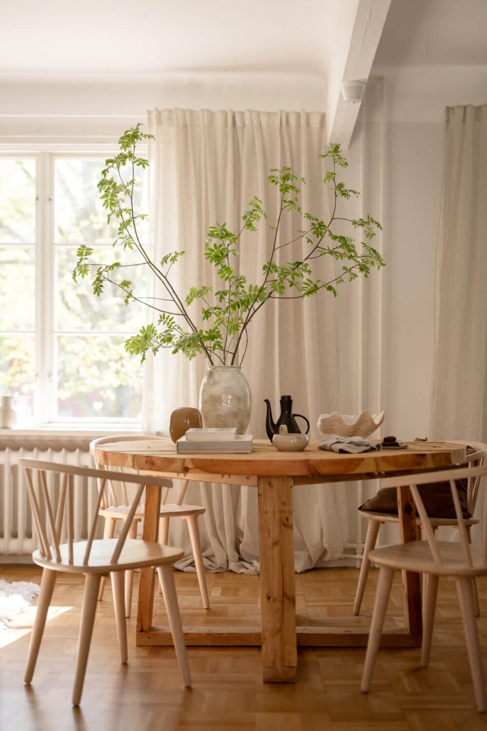 A Cozy Swedish Apartment with a Walk-In Pantry in the Sage Green Kitchen 4 rustic round wooden table