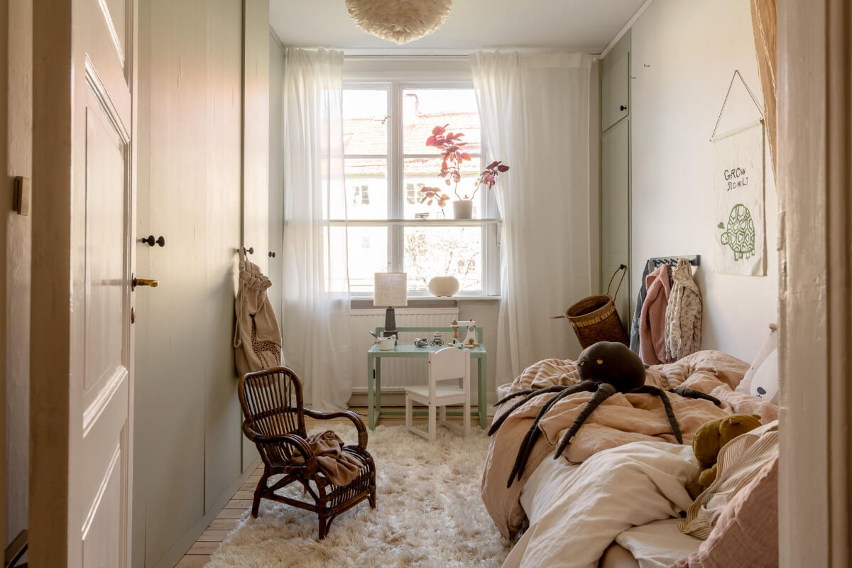 A Cozy Swedish Apartment with a Walk-In Pantry in the Sage Green Kitchen 29 shelf in front of window