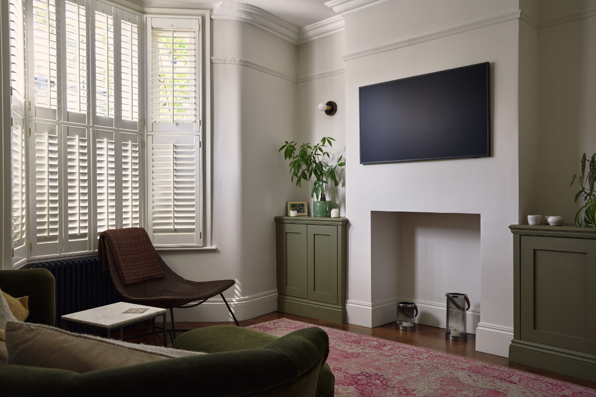 Moody Tones in a Restored and Extended Victorian Home in London 9 sitting room bay window pink rug