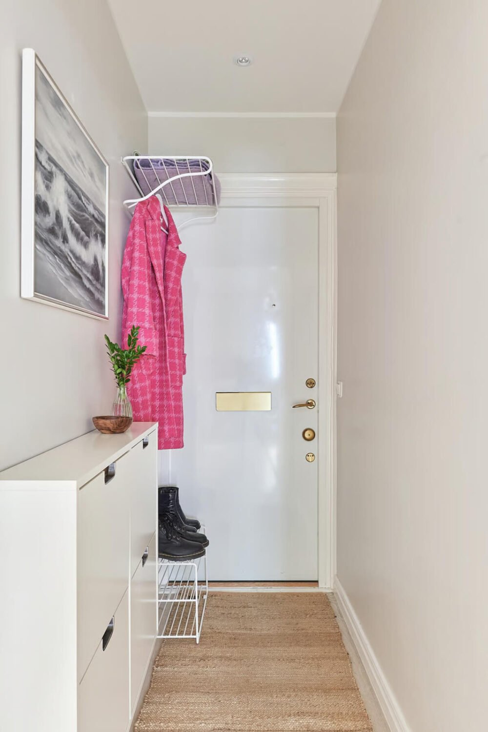 A Green Swedish Corner Apartment with an Open Floor Plan 20 small hallway with white shoe cabinets