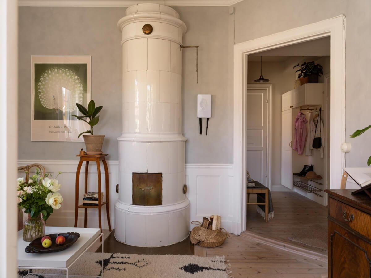 A Small Light-Filled Corner Apartment with Original Details 3 small living room paneling fireplace