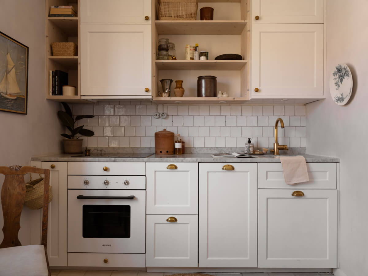 A Small Light-Filled Corner Apartment with Original Details 14 tiny white kitchen with open cabinets