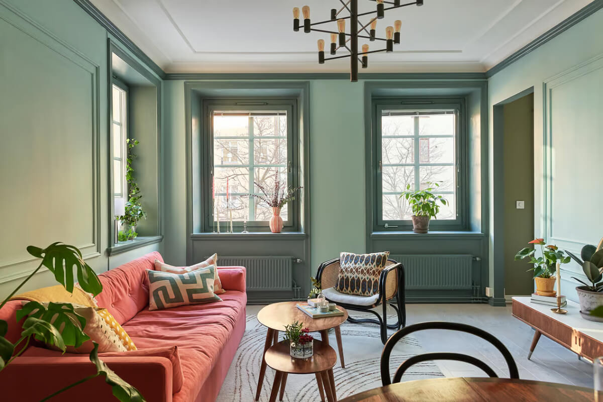A Green Swedish Corner Apartment with an Open Floor Plan 2 two-tone green living room pink sofa