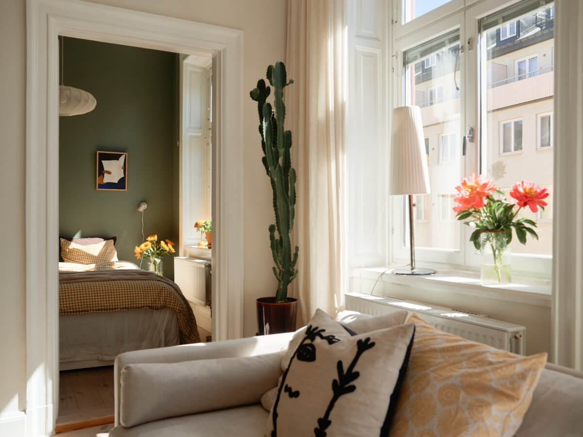 A Light-Filled Stockholm Apartment with Bright Color Pops 11 view into bedroom