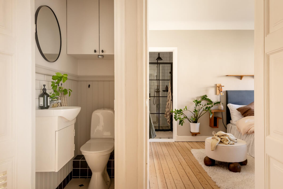 A Cozy Swedish Apartment with a Walk-In Pantry in the Sage Green Kitchen 26 view into bedroom and bathroom