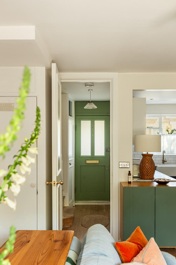 An Open-Plan Living Space and Colorful Bedrooms in a London Duplex 5 view into hall green front door