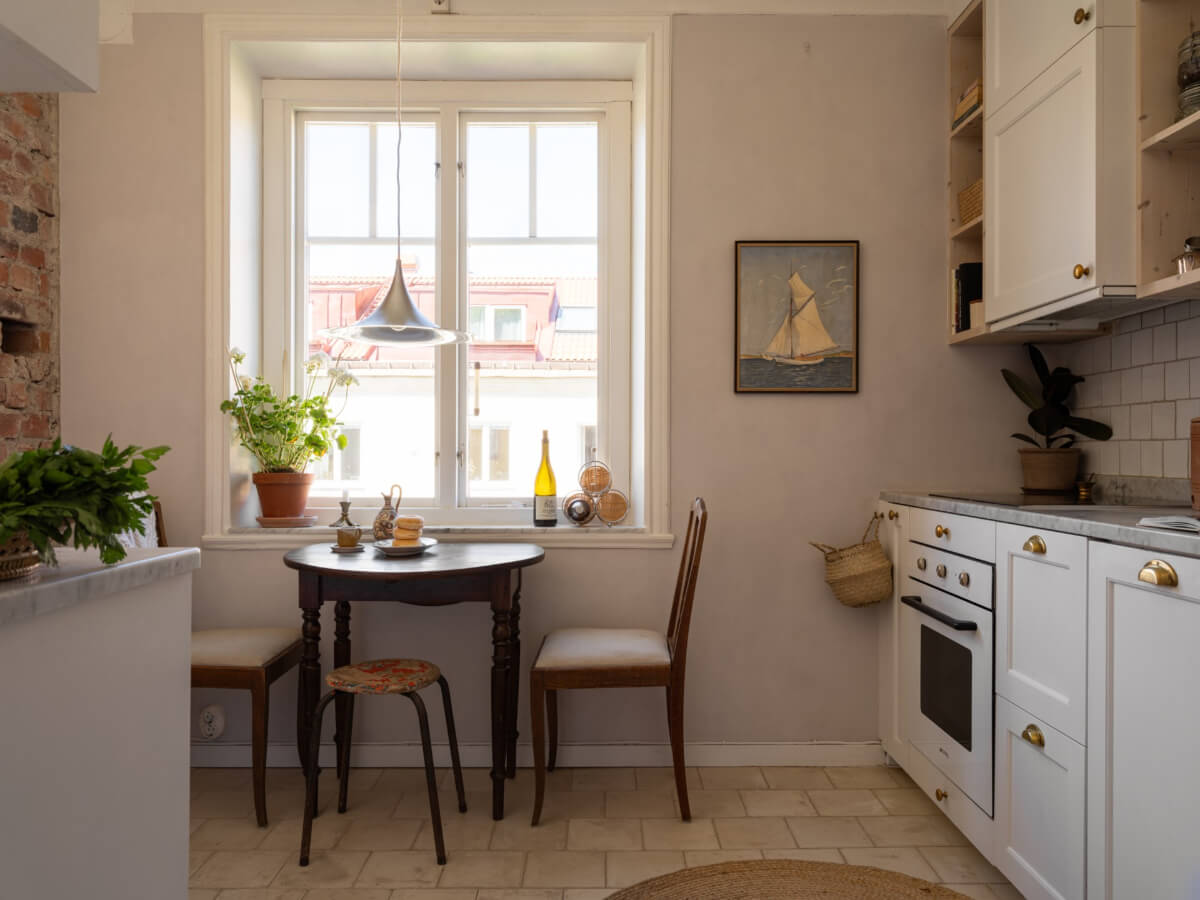 A Small Light-Filled Corner Apartment with Original Details 11 white kitchen cabinets brass fittings
