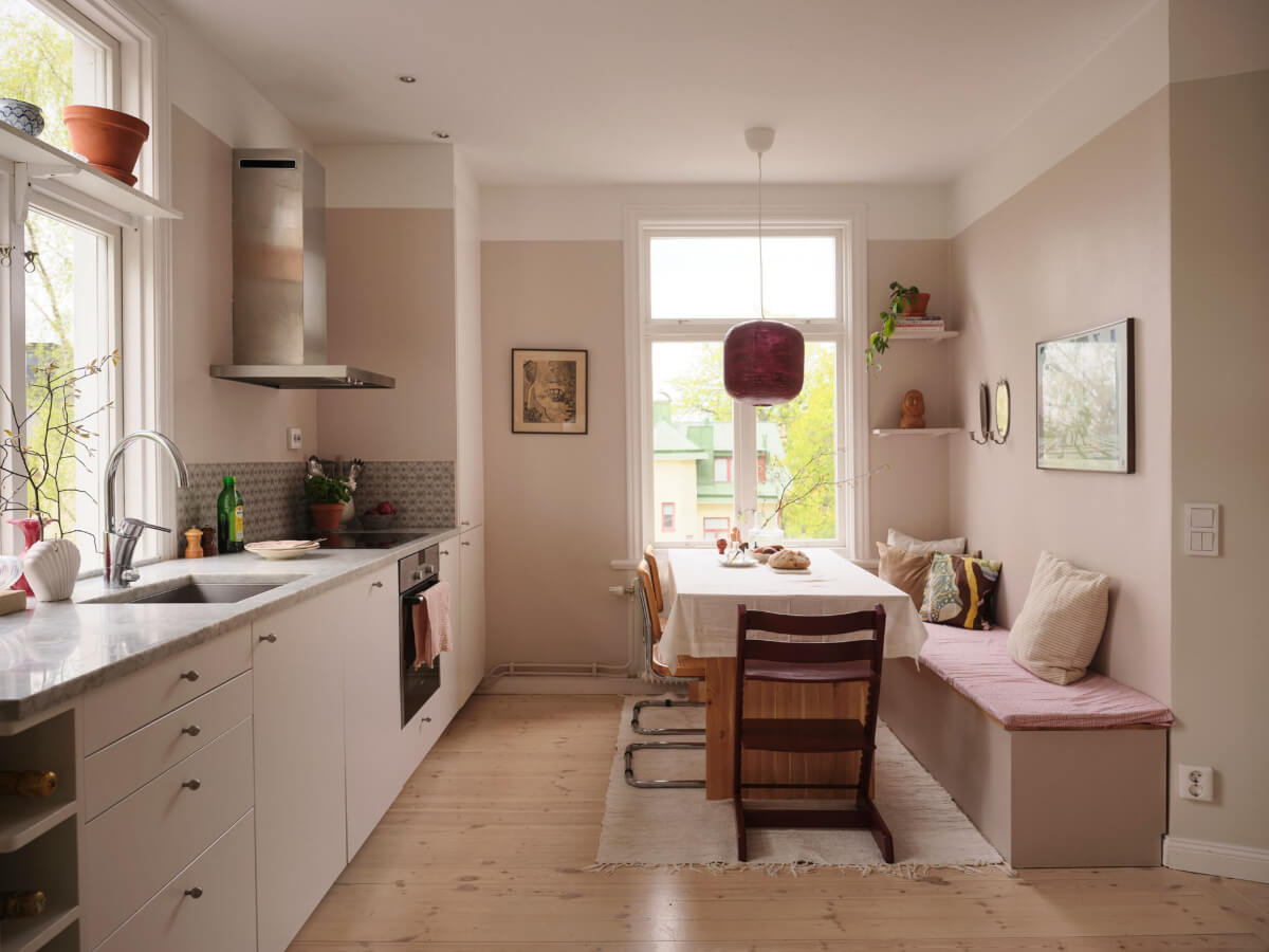 A Light Ground Floor Apartment with a Large Terrace 11 white kitchen pink walls dining table with built-in bench