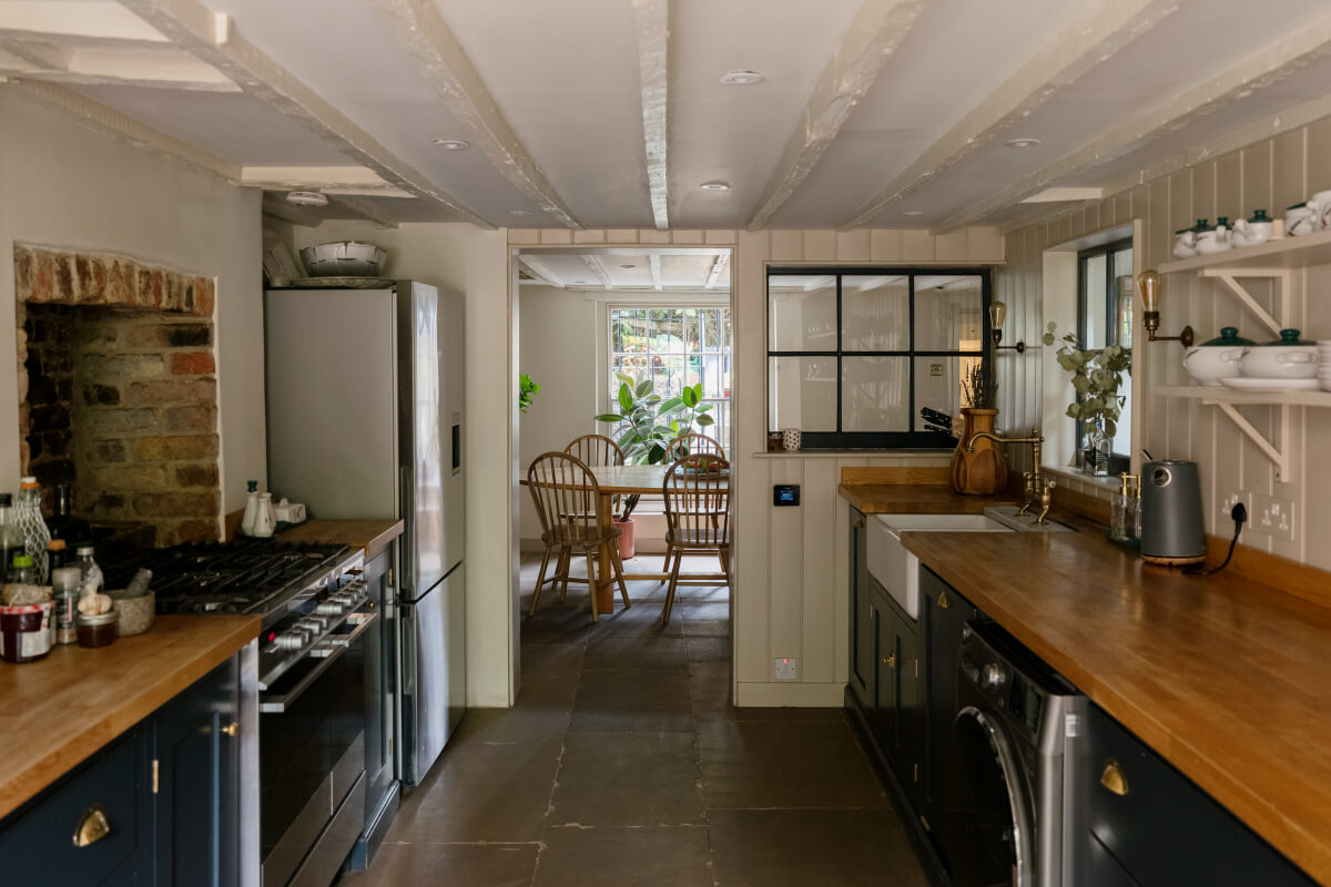 basement kitchen dark blue cupboards wooden countertop