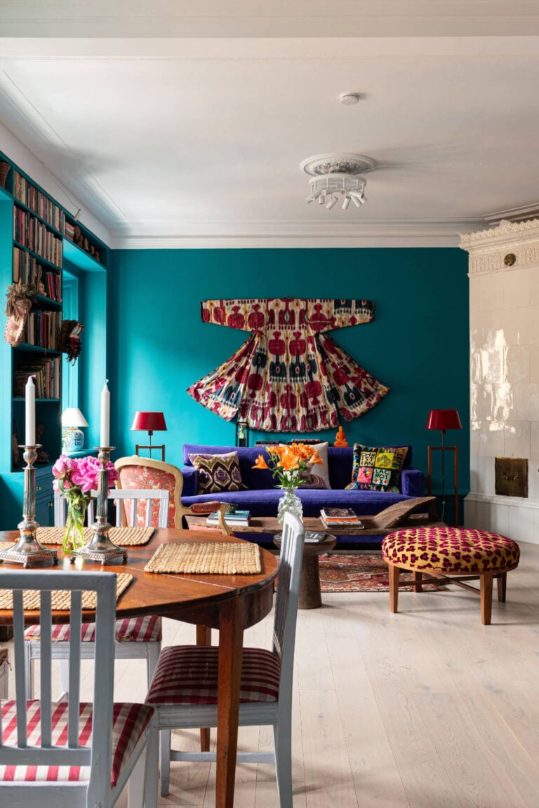 colorful living room built-in bookshelves fireplace teal colored walls