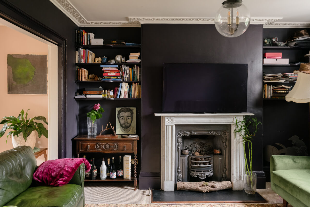 dark sitting room fireplace bookshelves