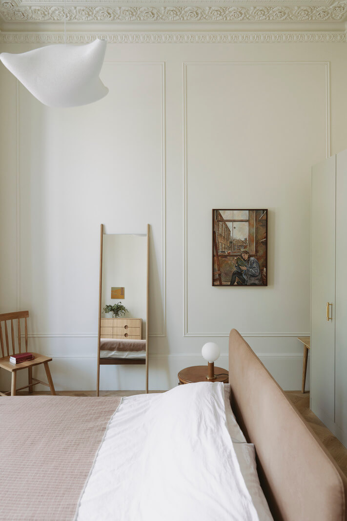 Grand Proportions and Bay Windows in a Belsize Park Apartment 18 high ceilings stucco bedroom with wardrobes behind bed