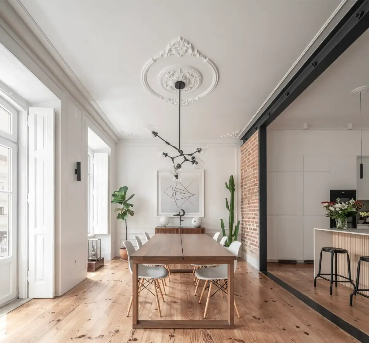 open plan kitchen and dining room exposed brick steel frame A Light-Filled Duplex Apartment in a Classical Lisbon Building