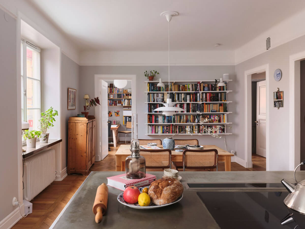 open plan kitchen dining space bookshelves