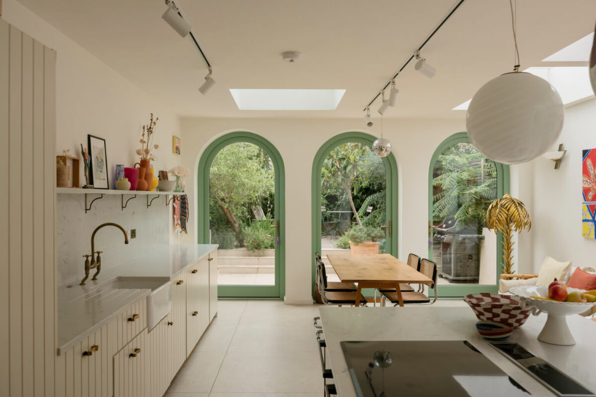 open plan kitchen living space green arched windows