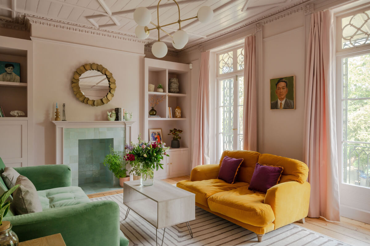 pink sitting room with light green tiled fireplace