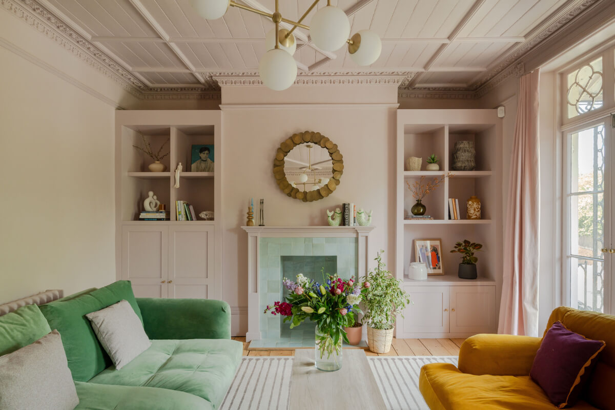 sitting room light pink walls green and yellow sofa