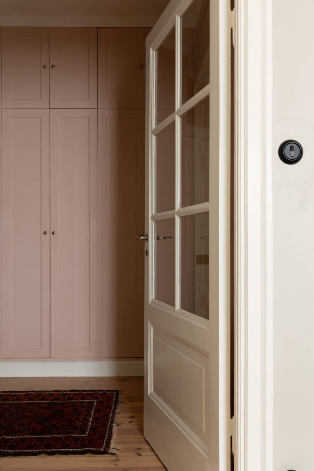timber glass door to hall with pink wardrobes