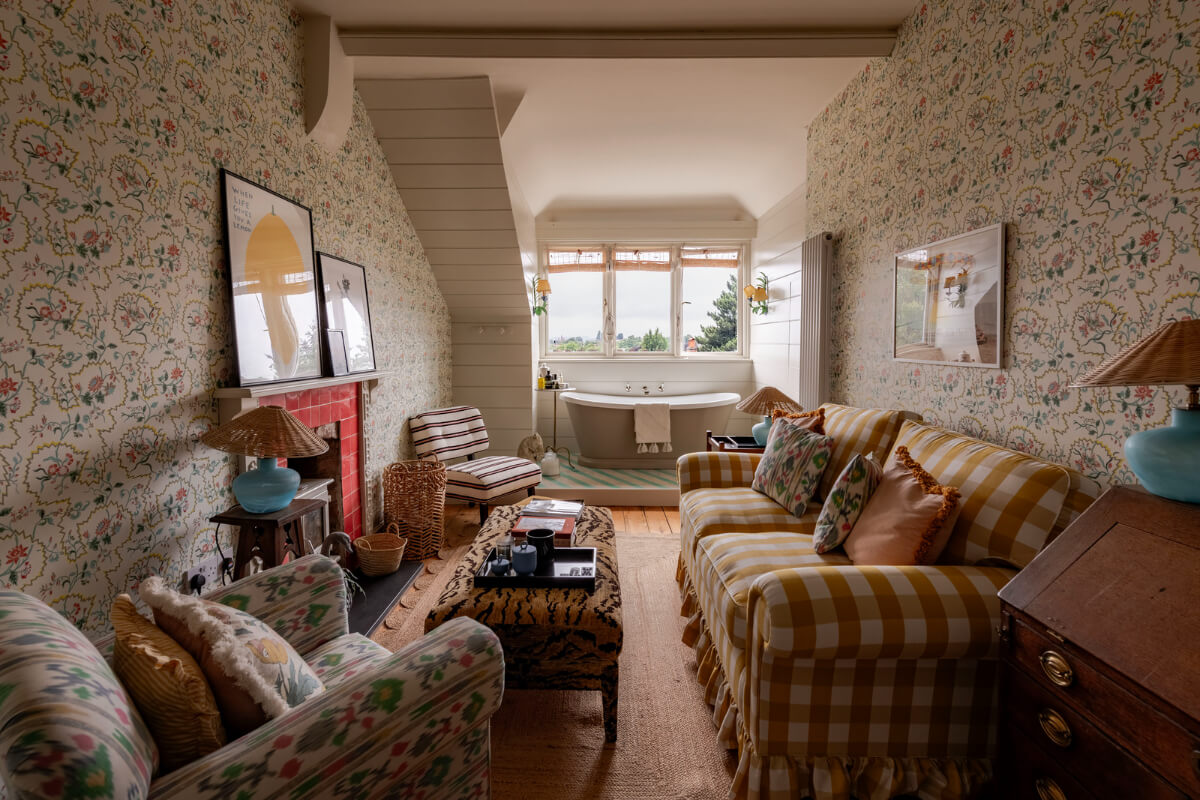 attic room with freestanding bath and fireplace