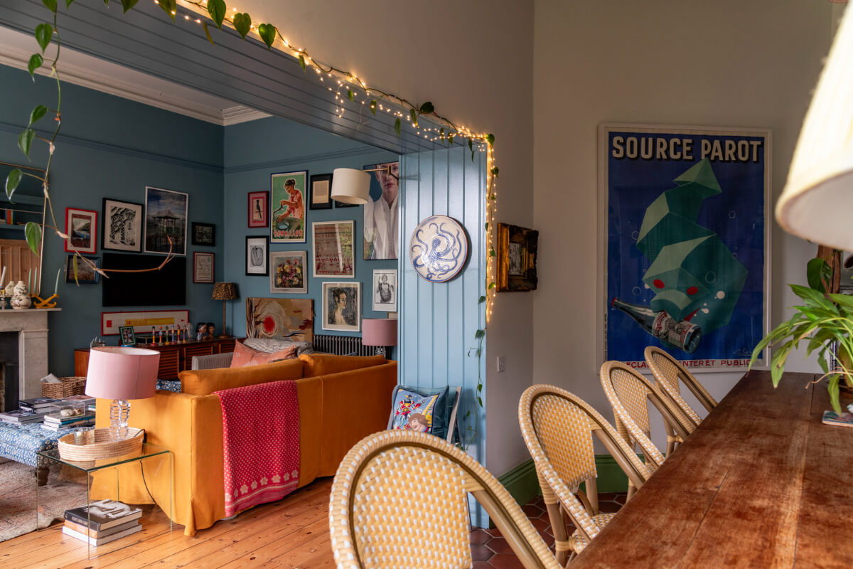 blue sitting room ochre sofa string lights